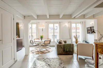 a living room with a table and chairs at Appartement Cezanne - Welkeys in Aix-en-Provence