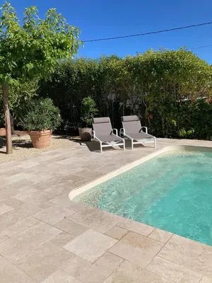 two chairs and a swimming pool in a yard at Chambre d'hôtes de la cime in Cabrières-dʼAigues
