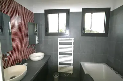 a bathroom with a sink and a toilet and a tub at Maison contemporaine dans le village d'Eygalières in Eygalières