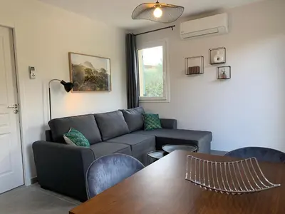 a living room with a couch and a table at Le Cabanon de Livia avec piscine privée in Cucuron