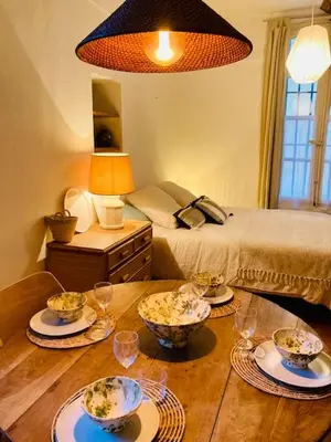a room with a table with bowls of food on it at Appartement de charme au coeur du vieux Aix. in Aix-en-Provence