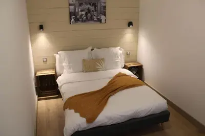 a bedroom with a large bed with a blanket on it at Chez Franck et Gisele in LʼIsle-sur-la-Sorgue