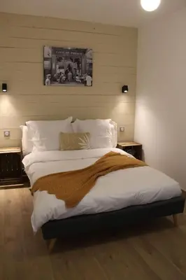 a bedroom with a large bed with white sheets and pillows at Chez Franck et Gisele in LʼIsle-sur-la-Sorgue