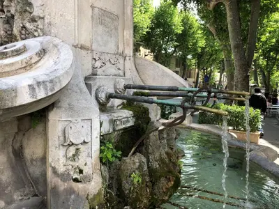 a water fountain on the side of a building at Aix Homes 