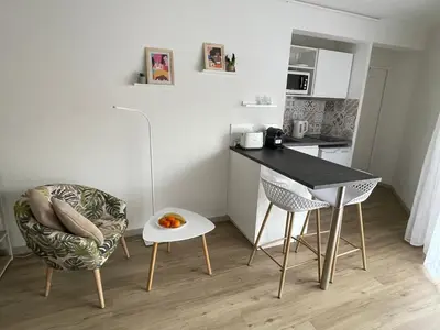 a small kitchen with a table and chairs in a room at Aix Homes 