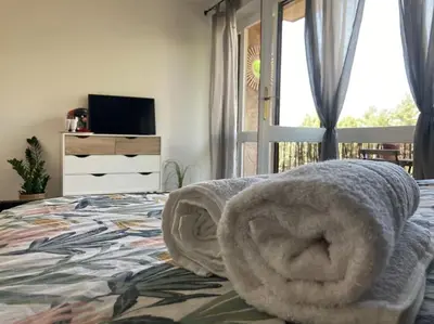 a bedroom with a bed with a towel on it at Cozy Studio with balcony and free parking in Aix-en-Provence