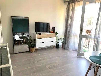 a living room with a tv and a dresser at Cozy Studio with balcony and free parking in Aix-en-Provence