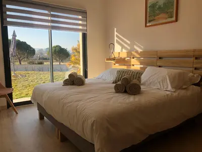 a bedroom with a bed with two hats on it at La Petite Reine in Villes-sur-Auzon