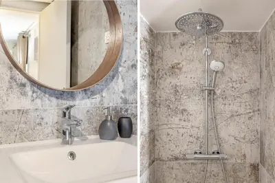 a bathroom with a shower and a sink and a mirror at Le Château Olive et Raisin in Fontaine-de-Vaucluse