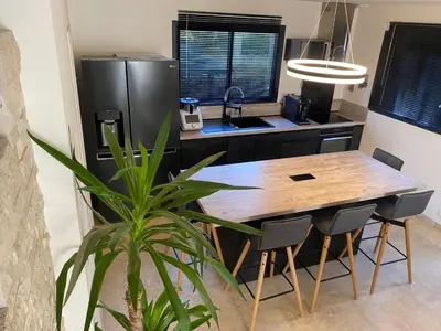 a kitchen with a large wooden table and chairs at Luxury House Family’s in Carpentras