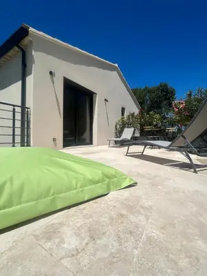 a green pillow on the ground in front of a house at Luxury House Family’s in Carpentras