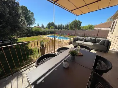 a patio with a table and chairs and a pool at Villa en Provence in Saint-Saturnin-les-Apt