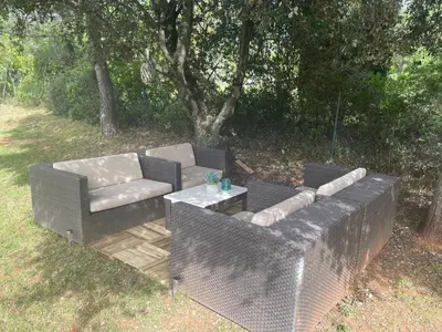 a couch and a table on a wooden deck at Villa en Provence in Saint-Saturnin-les-Apt