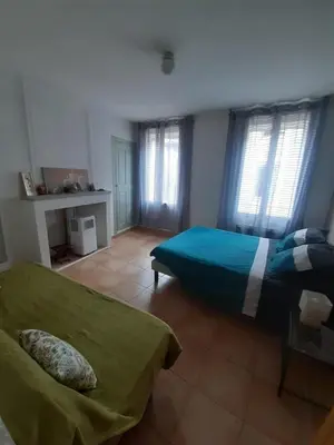 a bedroom with two beds in a room with windows at Apt en Luberon appartement 3 chambres et garage privée in Apt