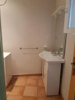 a bathroom with a white sink and a mirror at Apt en Luberon appartement 3 chambres et garage privée in Apt