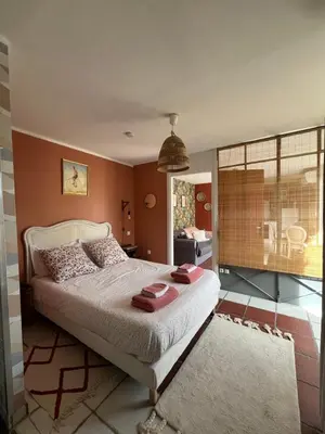 a bedroom with a bed with red towels on it at Terrama de l'isle in LʼIsle-sur-la-Sorgue