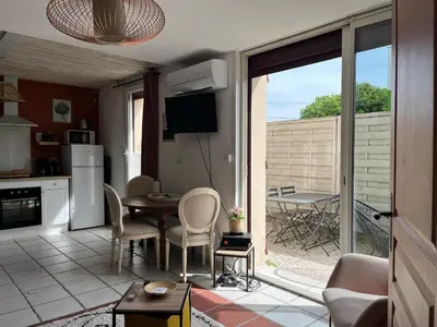 a kitchen and dining room with a table and chairs at Terrama de l'isle in LʼIsle-sur-la-Sorgue