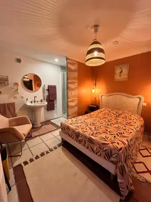 a bedroom with a bed and a bathroom with a sink at Terrama de l'isle in LʼIsle-sur-la-Sorgue