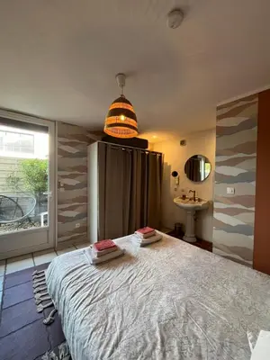 a bedroom with a large bed and a window at Terrama de l'isle in LʼIsle-sur-la-Sorgue