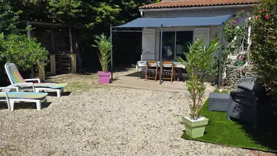 a backyard with chairs and a table and a tent at Le nid’Ange in Velleron