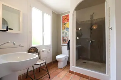 a bathroom with a shower and a sink and a toilet at magnificent detached villa with heated swimming pool and jacuzzi, in aureille, in the alpilles – 8 people in Aureille