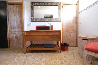 a bathroom with a wooden dresser and a mirror at magnificent detached villa with heated swimming pool and jacuzzi, in aureille, in the alpilles – 8 people in Aureille