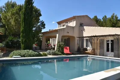 a swimming pool in front of a house at magnificent detached villa with heated swimming pool and jacuzzi, in aureille, in the alpilles – 8 people in Aureille
