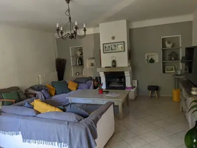 a living room with a couch and a table at Mas dans les lavandes in Ménerbes