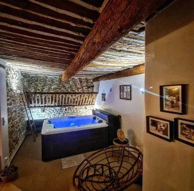 a large bathroom with a blue tub in a room at L' ecurie de Florent et Spa in Cheval-Blanc