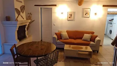 a living room with a couch and a table at L' ecurie de Florent et Spa in Cheval-Blanc