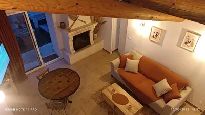 an overhead view of a living room with a couch and a fireplace at L' ecurie de Florent et Spa in Cheval-Blanc