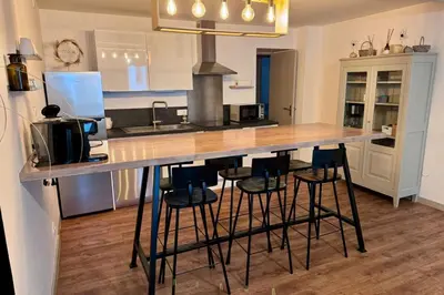 a kitchen with a counter with stools around it at 
