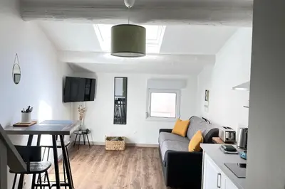 a living room with a couch and a table at Under the Provençal Sun in LʼIsle-sur-la-Sorgue