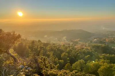 a view from the top of a hill at sunset at Under the Provençal Sun in LʼIsle-sur-la-Sorgue