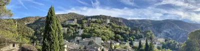 a town on top of a mountain with trees at Under the Provençal Sun in LʼIsle-sur-la-Sorgue