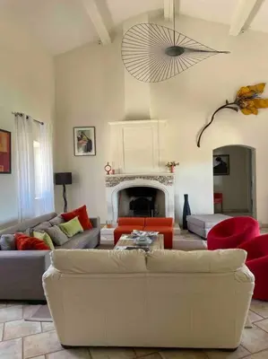 a living room with a couch and a fireplace at La Cath - Villa avec piscine - Gordes in Gordes