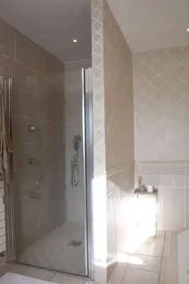 a shower with a glass door in a bathroom at La Cath - Villa avec piscine - Gordes in Gordes