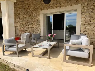 a patio with chairs and a table and a table and chairs at La Cath - Villa avec piscine - Gordes in Gordes