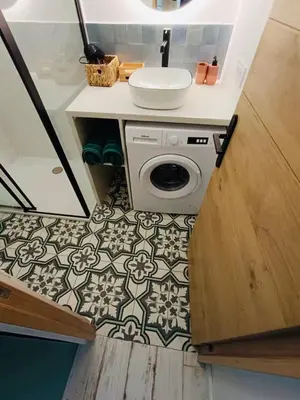 a bathroom with a sink and a washing machine at Gîte Mas La Bohème Piscine Parking Privé L'Isle-Sur-La-Sorgue in LʼIsle-sur-la-Sorgue
