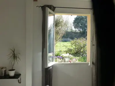 a window with a view of a garden with flowers at Campagne de Saint Clair in Pertuis
