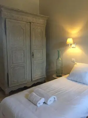 a bedroom with a bed with two towels on it at Bastide la Melonnerie in Lacoste