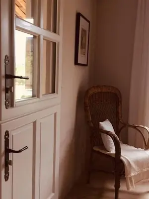 a room with a door and a chair and a window at Bastide la Melonnerie in Lacoste