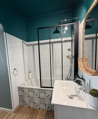 a bathroom with a tub and a sink and a mirror at Sasha'blue-terrasse jardin-park-clim-piscine in LʼIsle-sur-la-Sorgue
