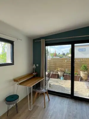 a room with a desk and a chair and a window at Logement entier avec jacuzzi en provence in Le Thor