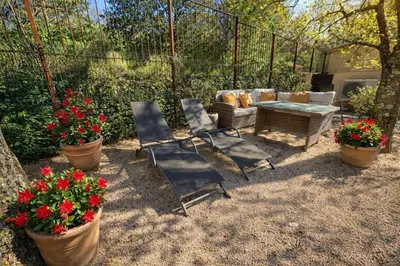 a table and four chairs in front of a swimming pool at Studio cosy à Lagnes avec Piscine au milieu des oliviers in Lagnes
