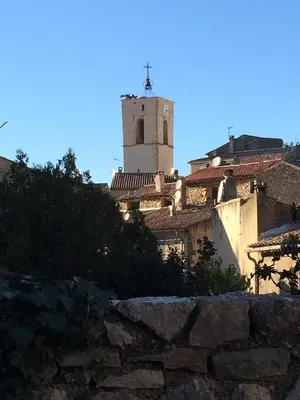 a building with a tower on top of it at La Reynière du Sud Luberon in La Bastide-des-Jourdans