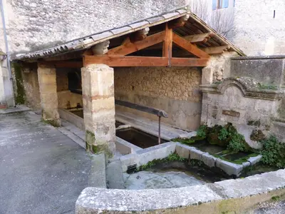 an outside view of a building with a wooden roof at La Reynière du Sud Luberon in La Bastide-des-Jourdans