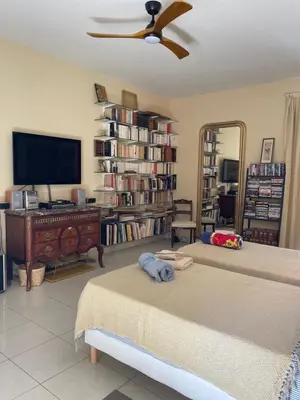 a living room with two beds and a flat screen tv at La Beaume in Blauvac