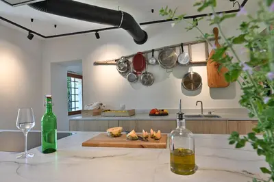 a kitchen with a counter with pots and pans on the wall at Le Pavadou B&B in Méthamis