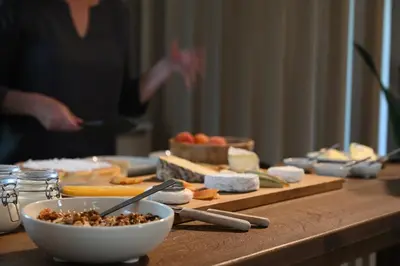 a table topped with cheese and a bowl of food at Le Pavadou B&B in Méthamis